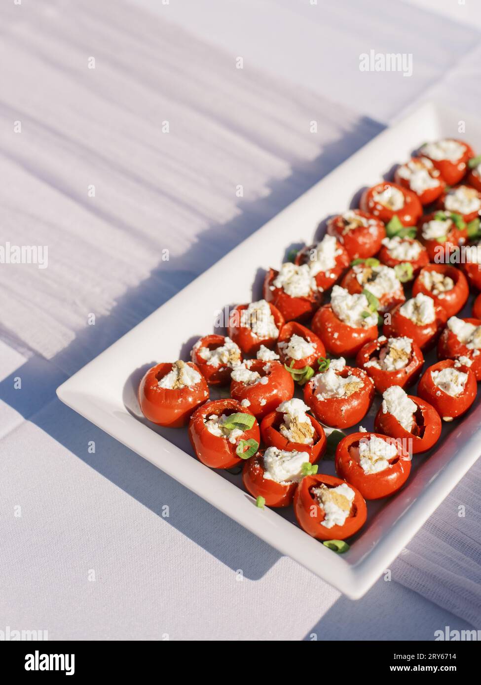 Tray of cheese-stuffed tomatoes, catered food Stock Photo