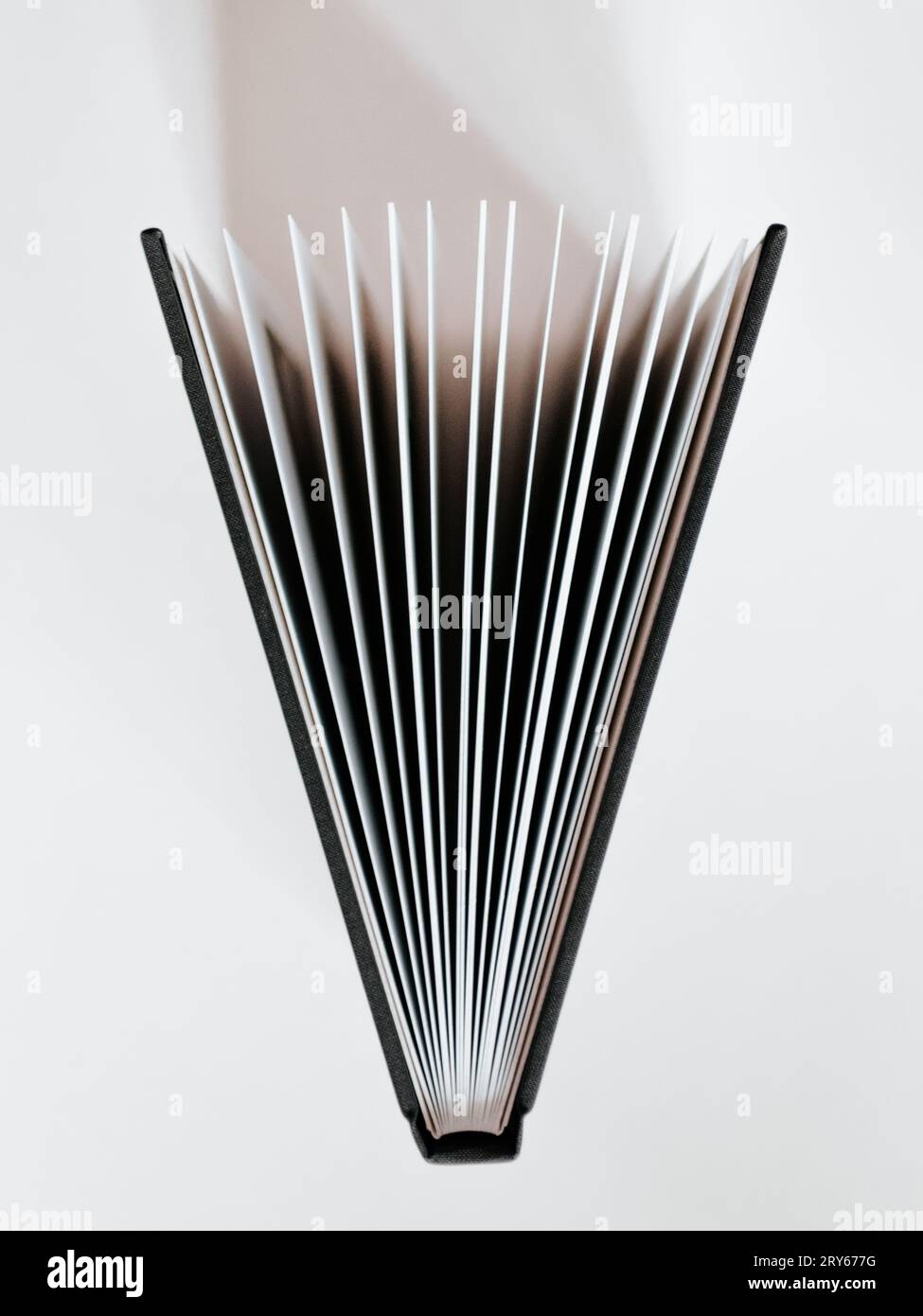 Open book on white table, top view Stock Photo