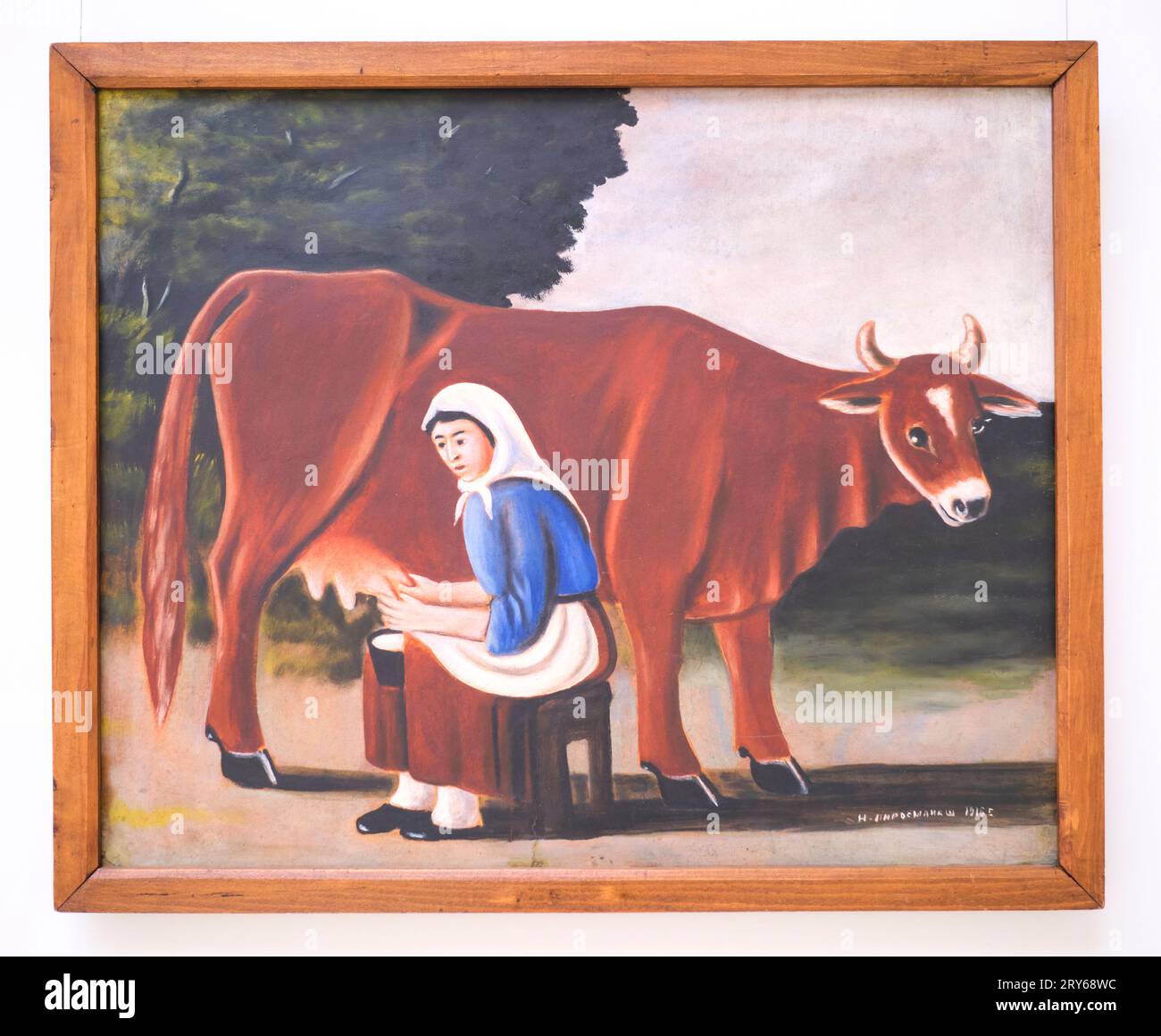 A classic, iconic painting by the artist, Niko Pirosmanashvili, titled, Woman Milking Cow. In Tbilisi, Georgia, Europe. Stock Photo