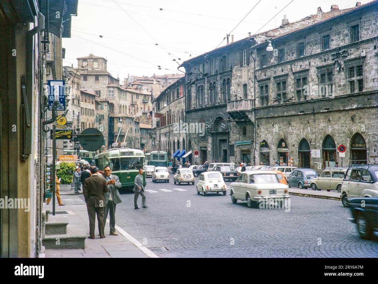 Traffic and tram cars of busy city street in Perugia, Umbria, Italy 1969 Stock Photo