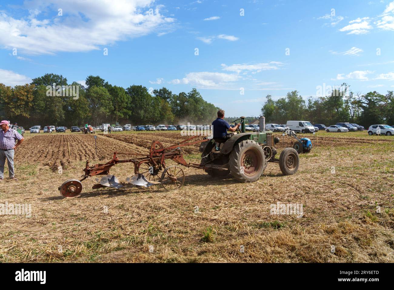 Competitors on vintage farm machinery taking place in a ploughing competition. Stock Photo
