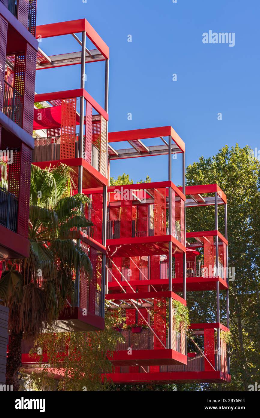 Montpellier, France - 09 25 2023 : Vertical view of bright red contemporary architecture of Version Rubis residential building by Jean-Paul Viguier Stock Photo