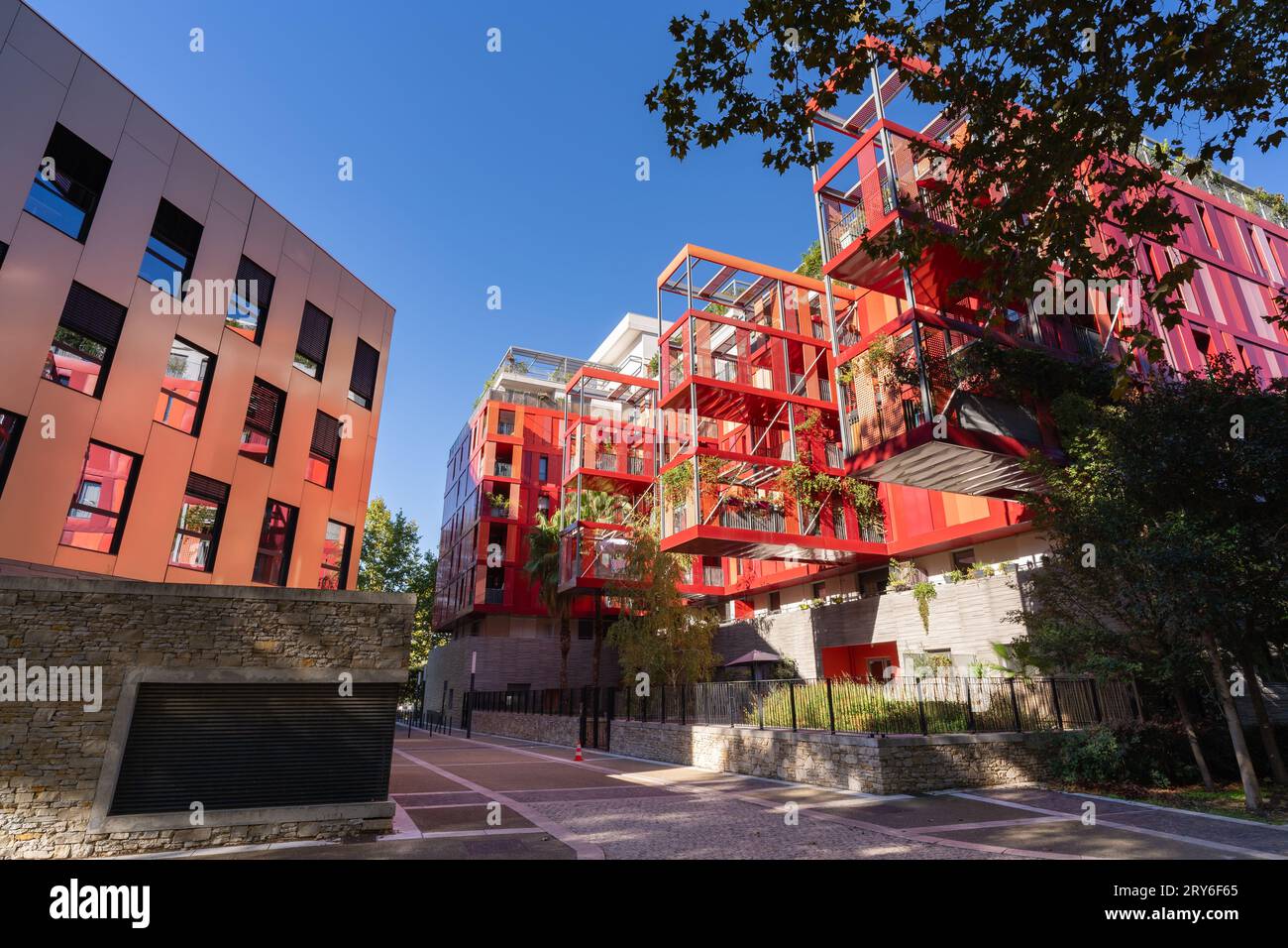 Montpellier, France - 09 25 2023 : Cityscape view of bright red modern architecture of Version Rubis apartment building by Jean-Paul Viguier Stock Photo