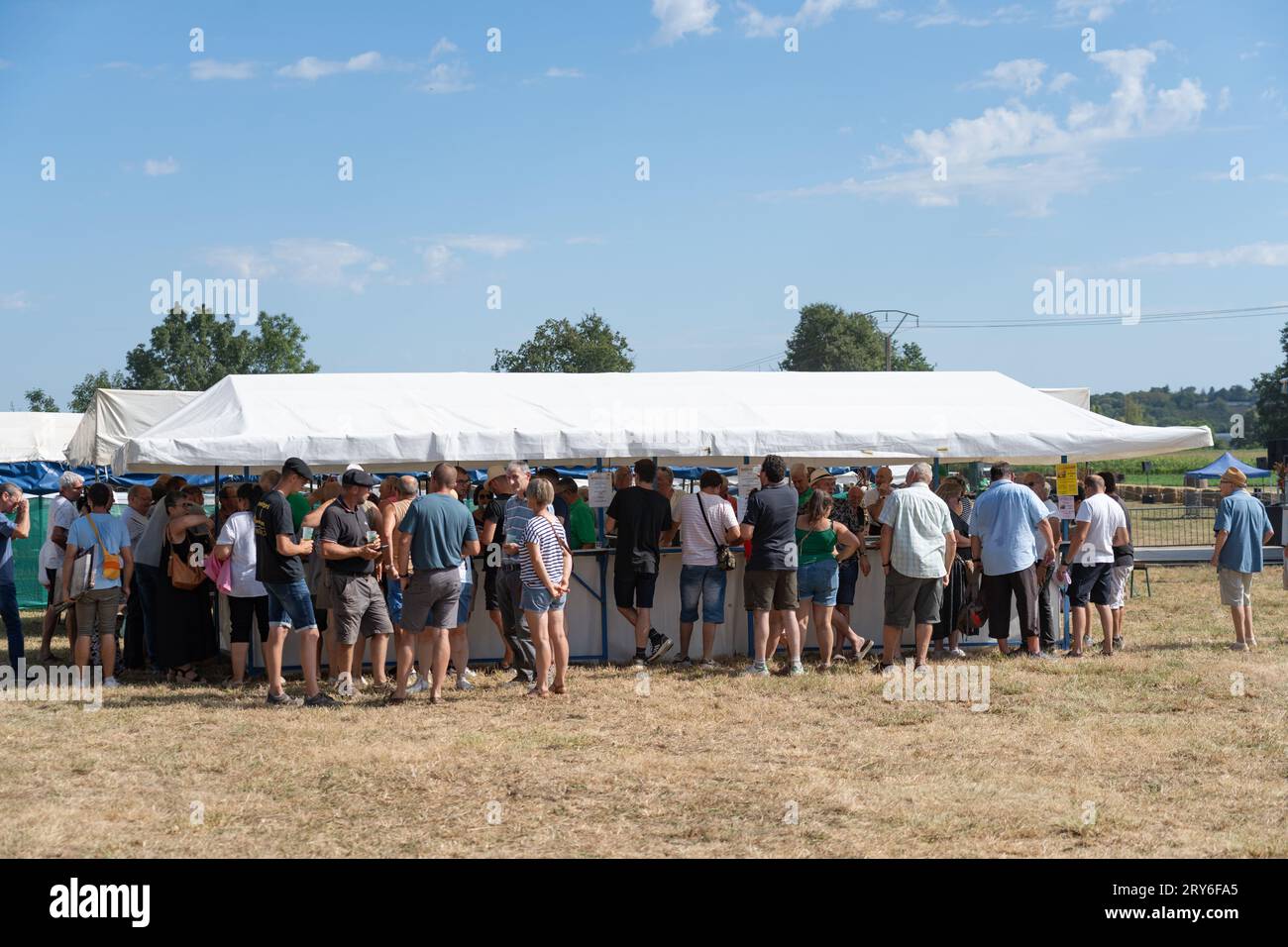 Farmers gather around the bar at a harvest festival Stock Photo