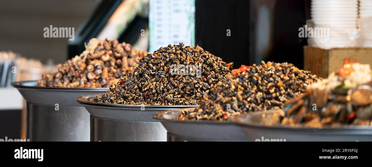 Stir-fried spicy flavored snail meat, delicious traditional street food in Taiwan. Stock Photo