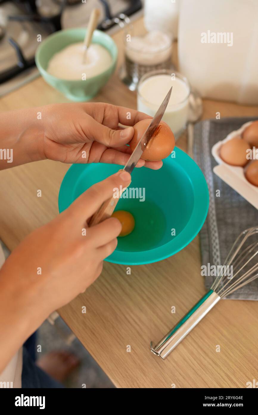 the process of breaking hen's eggs into a bowl, cracked shells Stock Photo Alamy