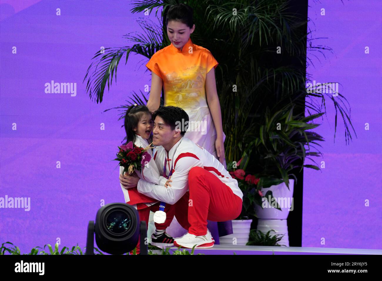 Silver medalist China's Chaopan Lin is greeted by his daughter after ...