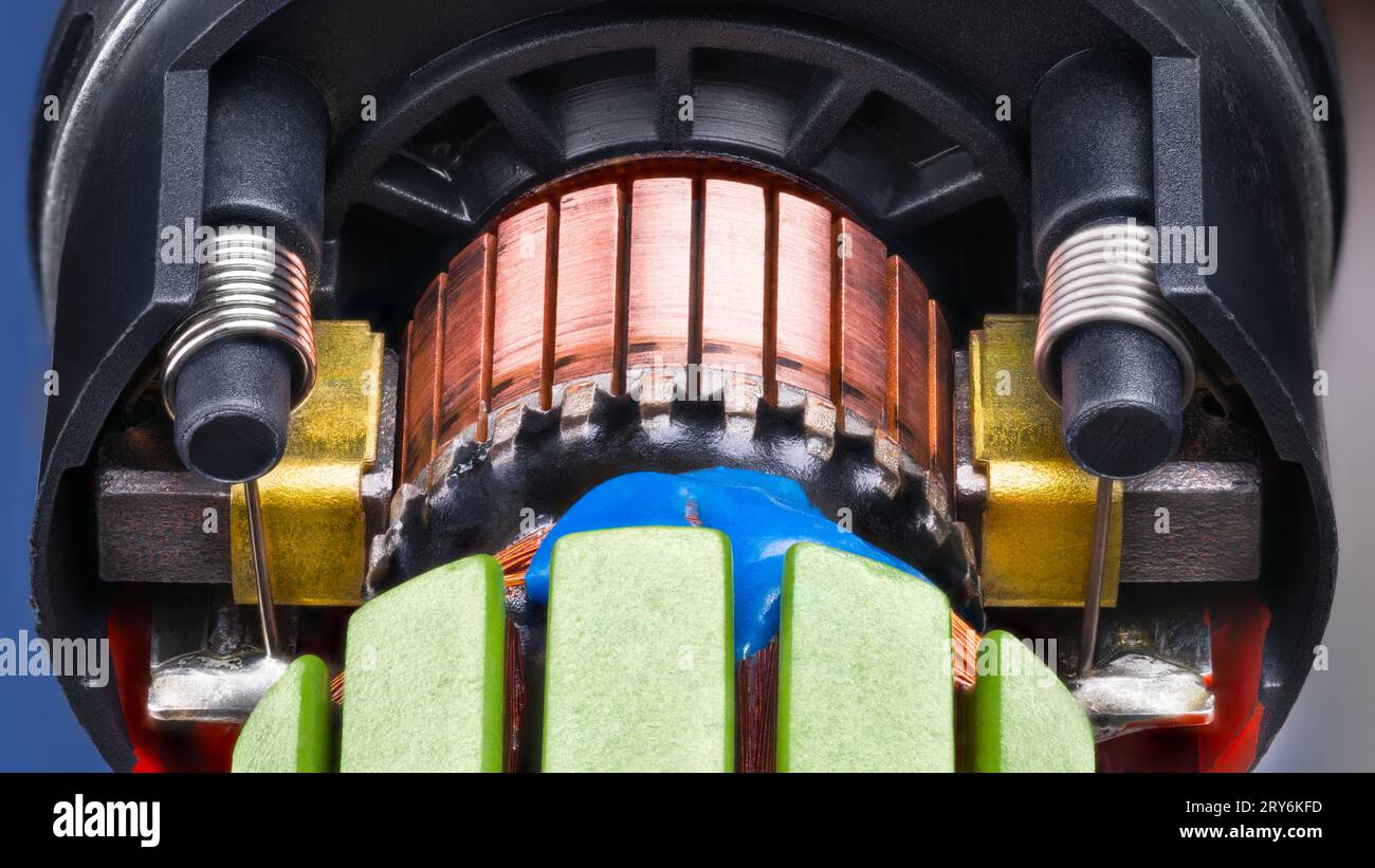 Closeup of electric DC motor rotor with copper wire fixed by blue
