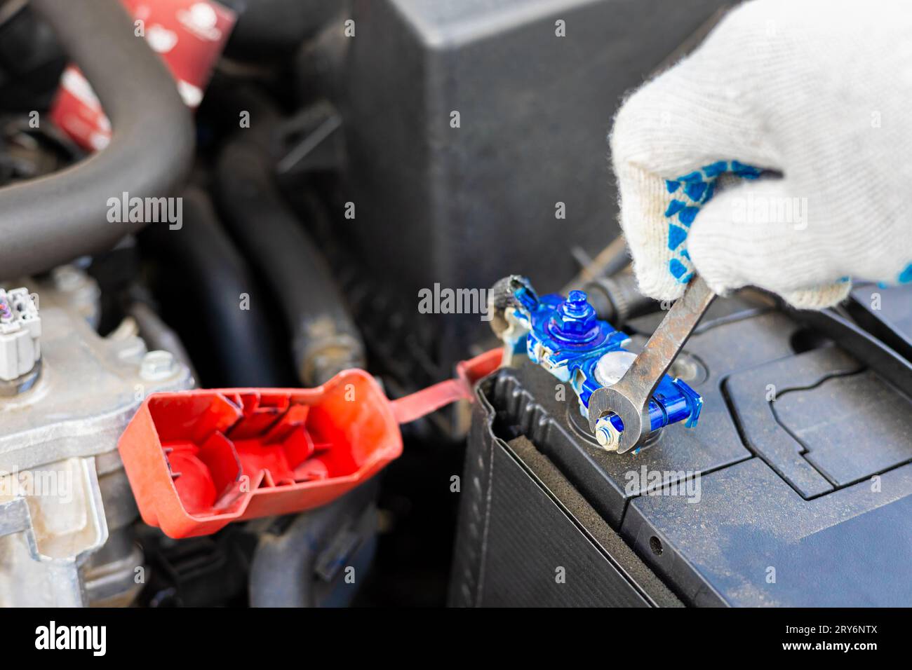 the driver is replacing the car battery. battery terminal installation