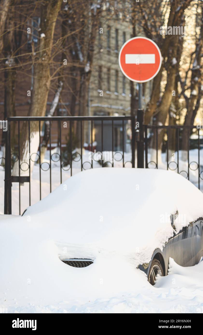 After snowstorm city traffic is halted because cars are fully buried in snow. Stock Photo
