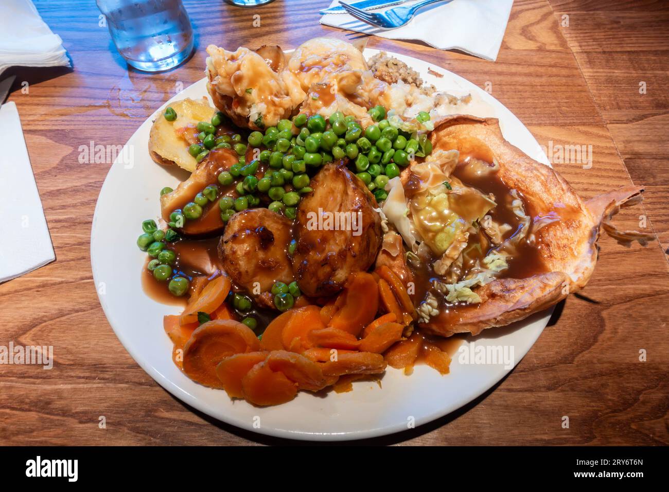 A large plate of food consisting of roast meats, Yorkshire pudding