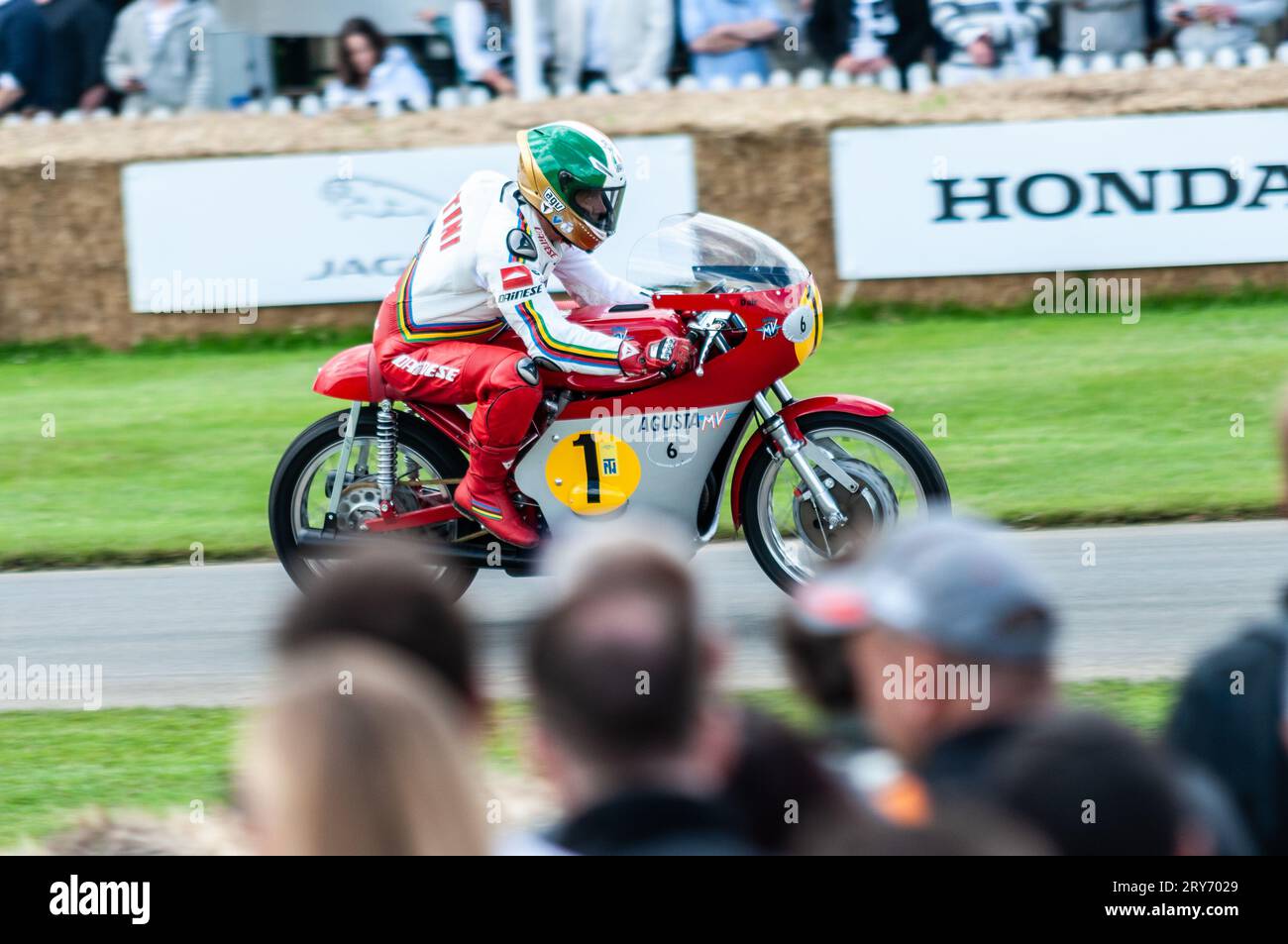 MV Agusta 500cc Three racing up the hill climb at the Goodwood Festival of Speed motorsport event, UK. Historic Grand Prix World Champion motorcycle Stock Photo