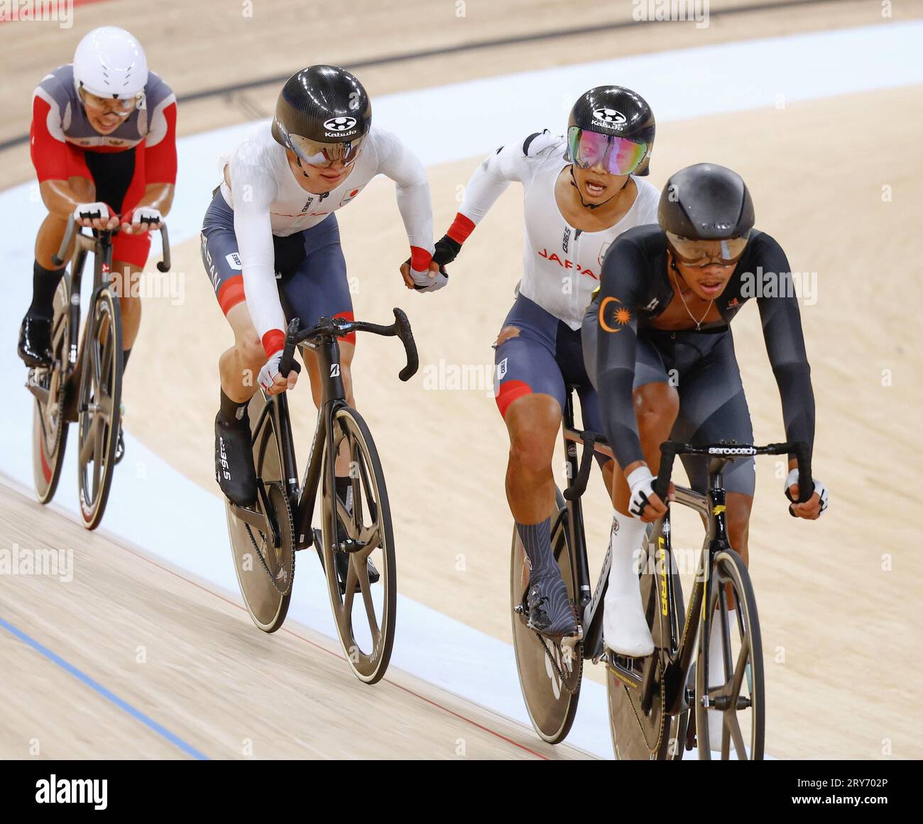 Japanese cyclists Naoki Kojima (C, L) and Shunsuke Imamura (C, R) compete en route to winning