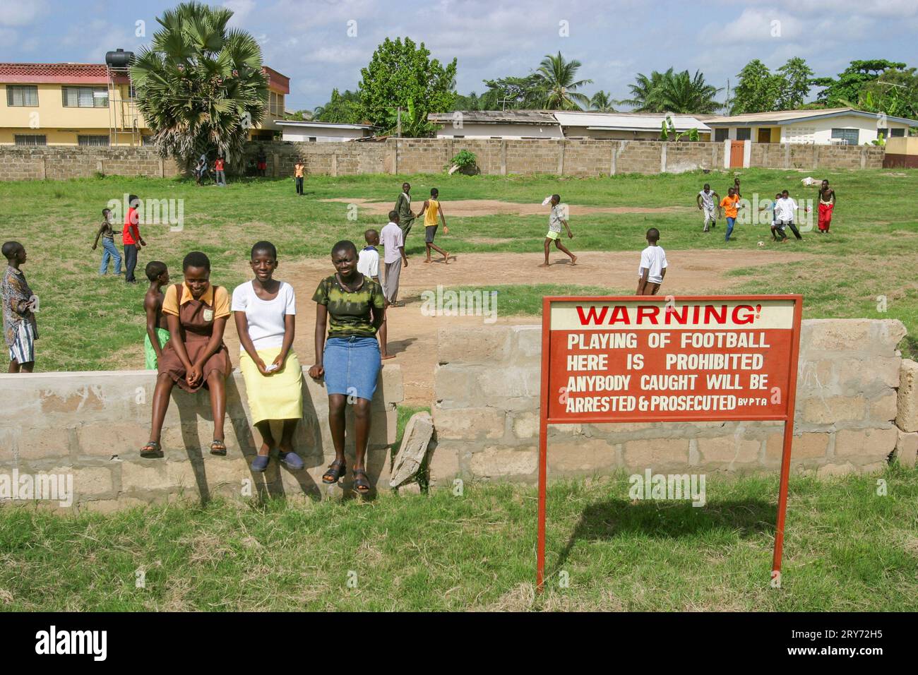 Ghana, Accra. Children play football, while a sign says  it is prohibited. Stock Photo