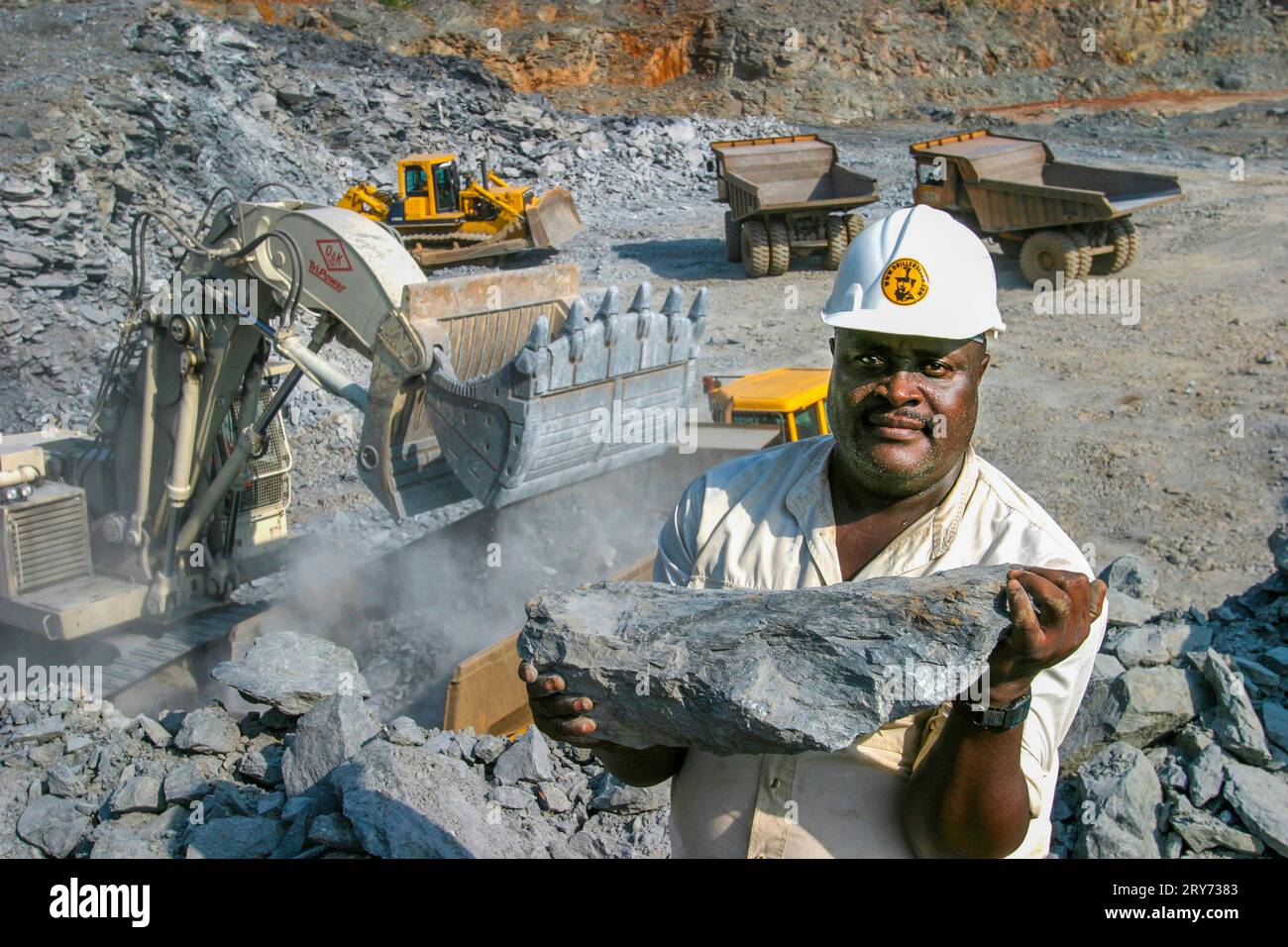 Ghana, Tarkwa. Overview of open pit with a miner of the mining company