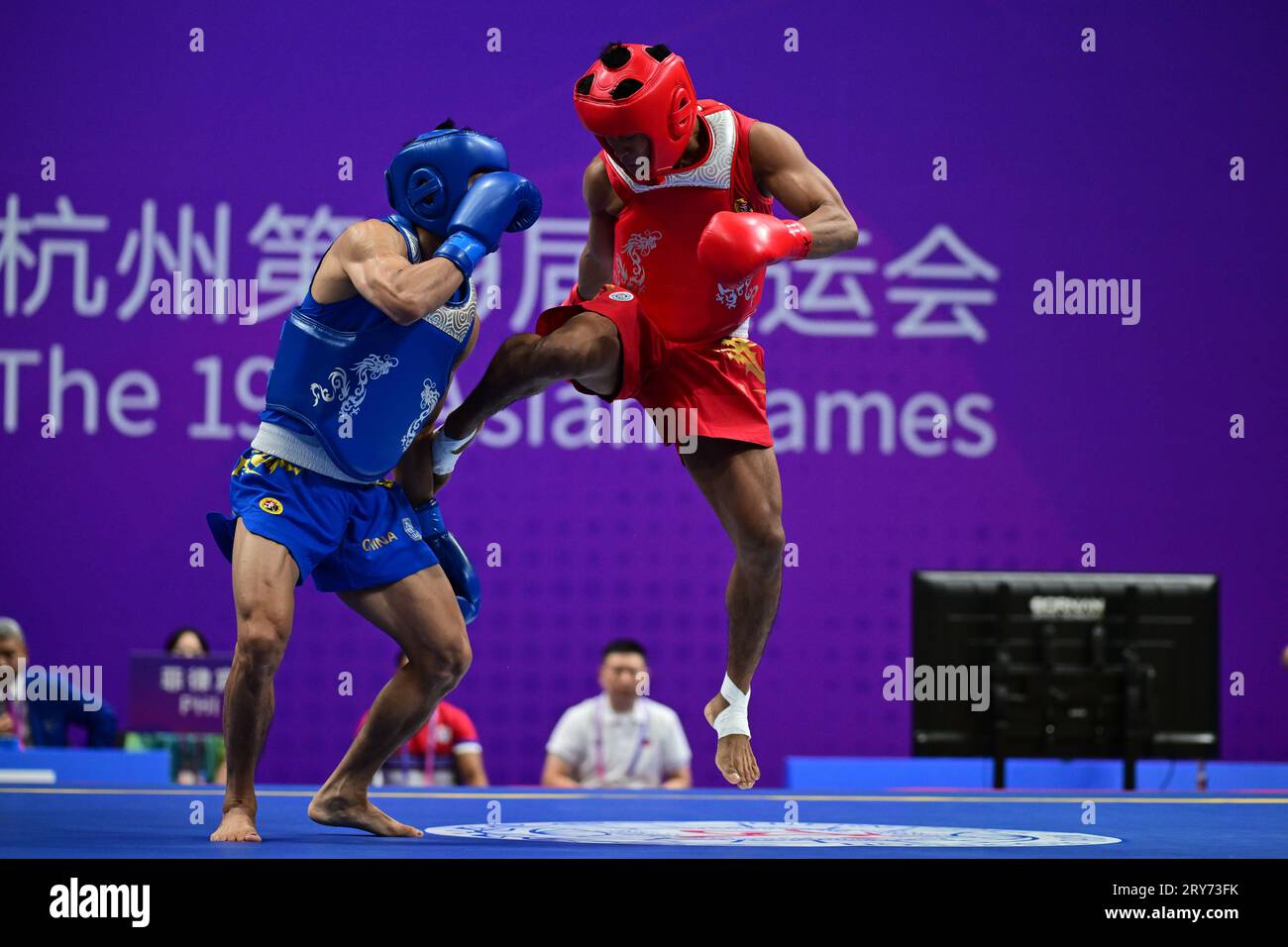 Hangzhou, China. 29th Sep, 2023. Arnel Mandal (R) of the Philippines and Jiang Haidong (L) of China compete during the Asian Games 2023, Wushu Sanda Men's 56Kg Final match at Xiaoshan Guali Sports Centre. Jiang won the match by point difference. Credit: SOPA Images Limited/Alamy Live News Stock Photo