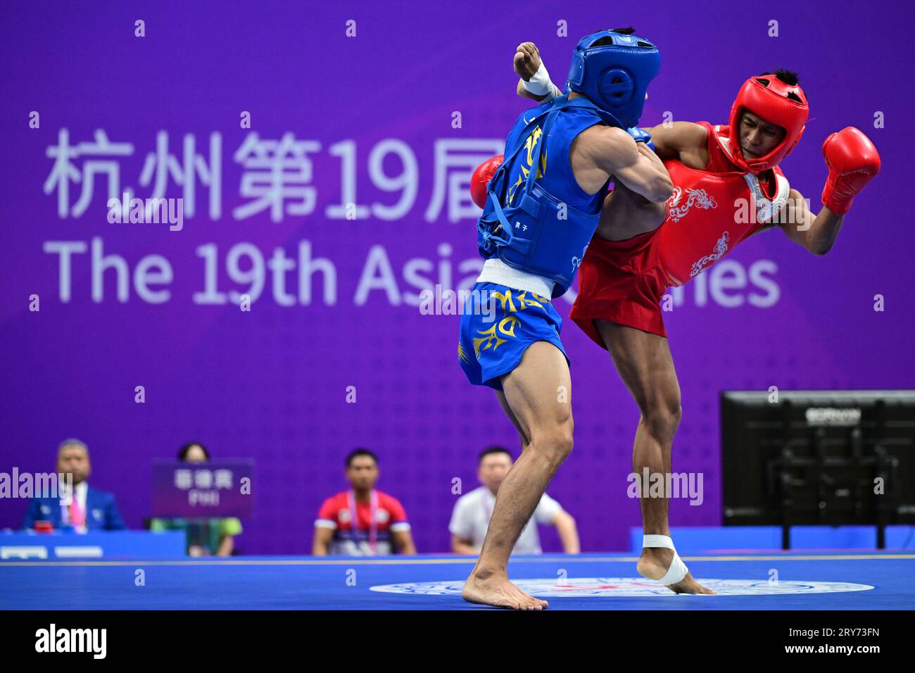 Hangzhou, China. 29th Sep, 2023. Arnel Mandal (R) of the Philippines and Jiang Haidong (L) of China compete during the Asian Games 2023, Wushu Sanda Men's 56Kg Final match at Xiaoshan Guali Sports Centre. Jiang won the match by point difference. Credit: SOPA Images Limited/Alamy Live News Stock Photo
