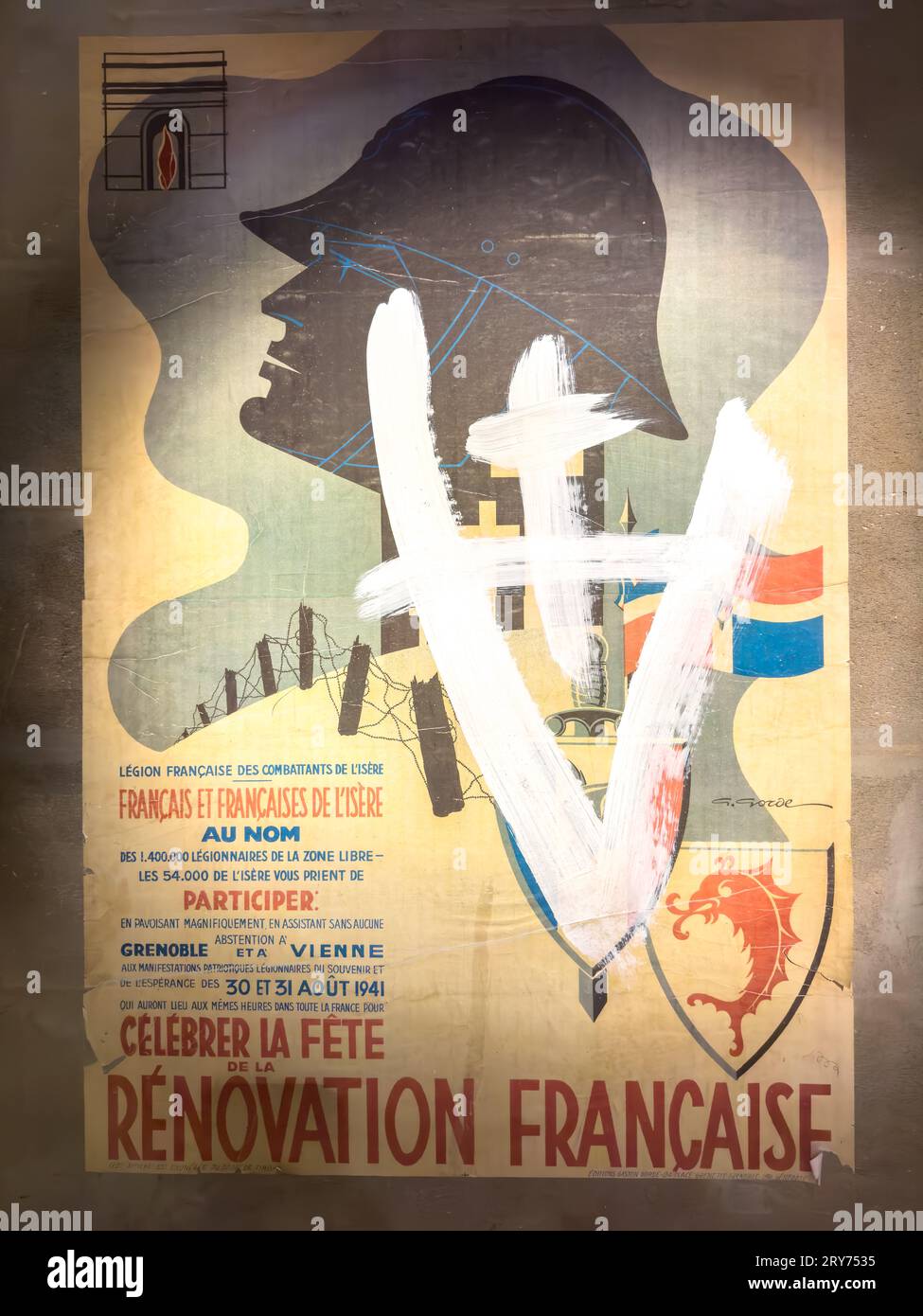 A WW2 Vichy French poster daubed with French Resistance graffiti on display in the Resistance & Deportation Museum, Grenoble, France. Stock Photo