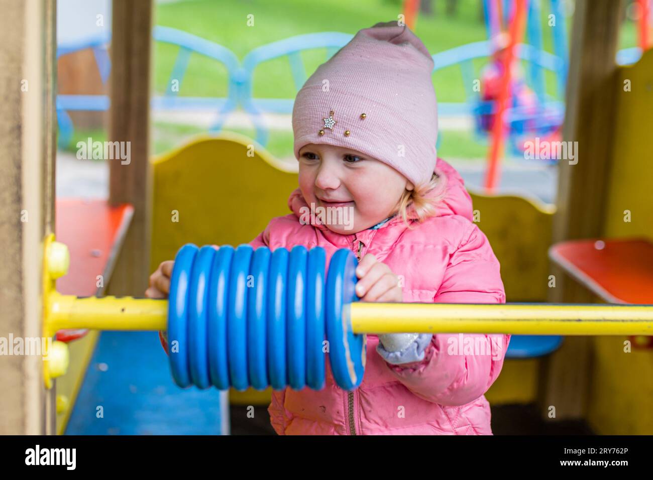 child in playground learns mathematics counting on large toy