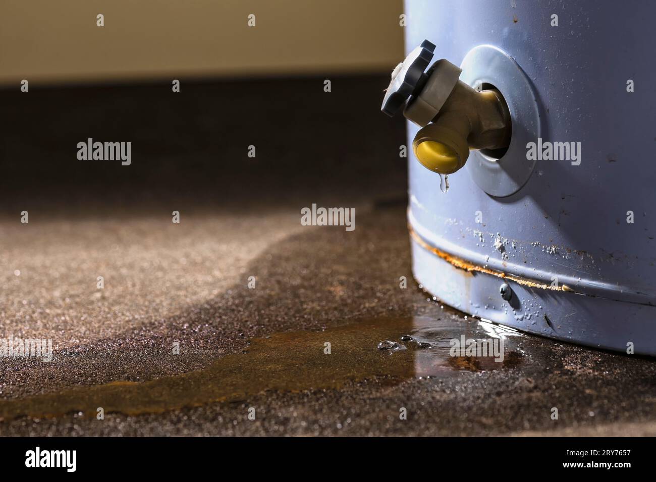 Water leaking from the plastic faucet on a residential electric water
