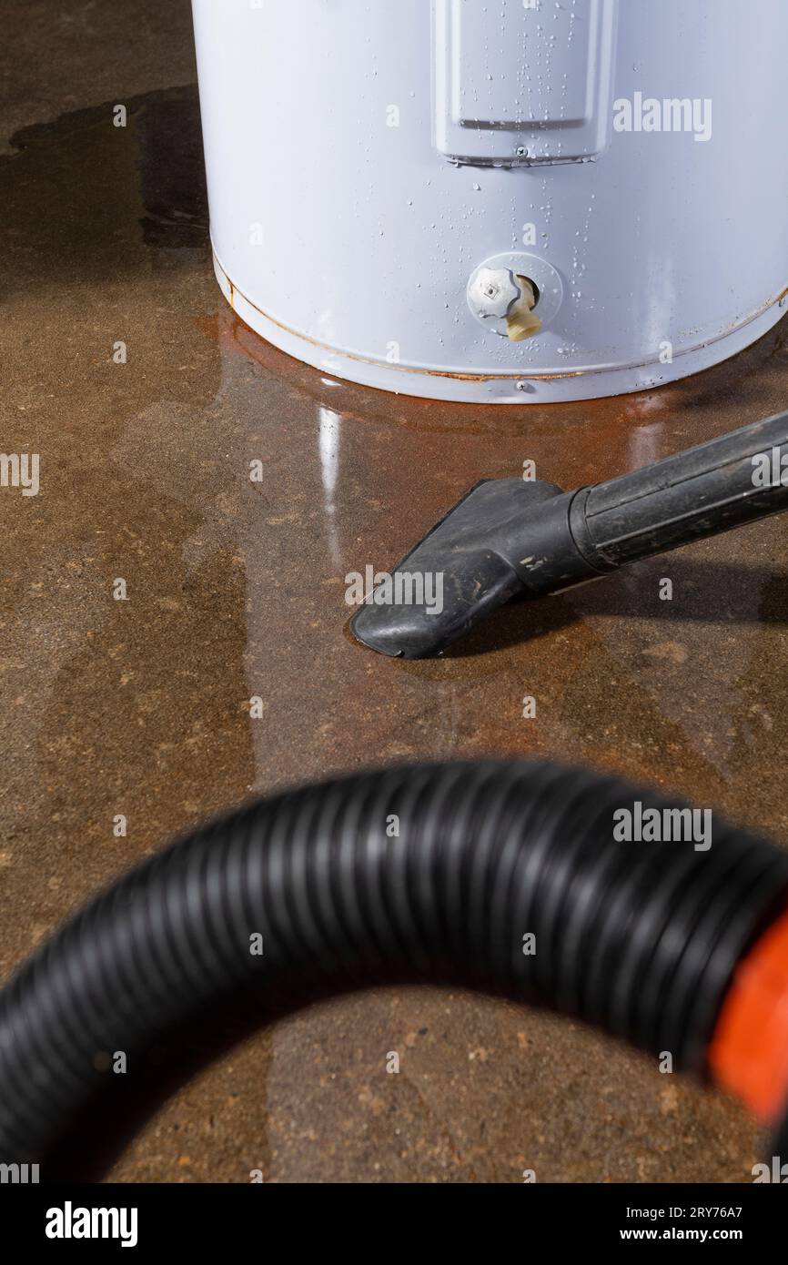 A wetdry vacuum being used to clean up water from a leaking