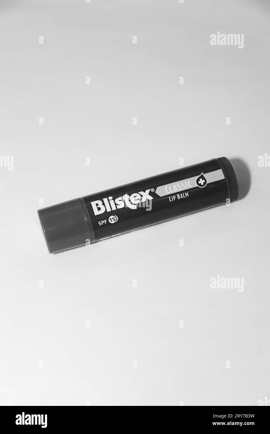 Black and white Blistex classic lip balm flavored with mint laying on white  background Stock Photo - Alamy