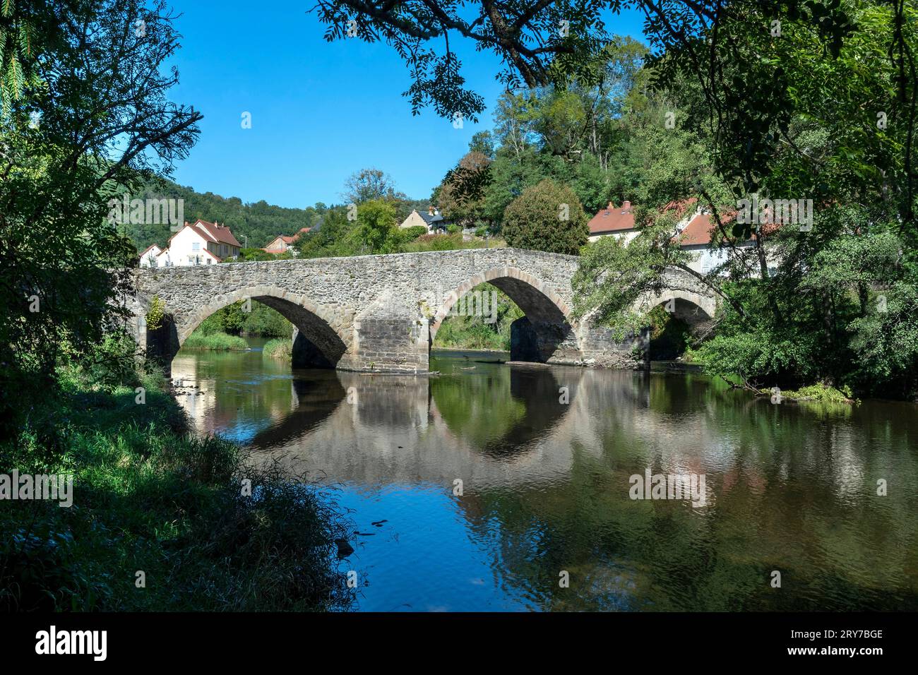 The old medieval bridge at Menat over the river Sioule. Puy de Dome department. Auvergne-Rhone-Alpes. France Stock Photo