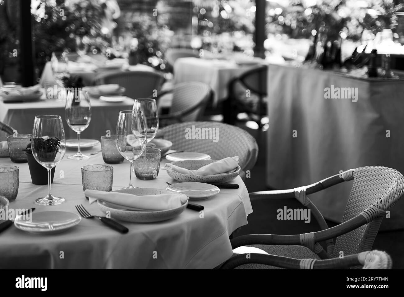 Cozy Spanish outdoor restaurant. Beautiful served tables and wicker