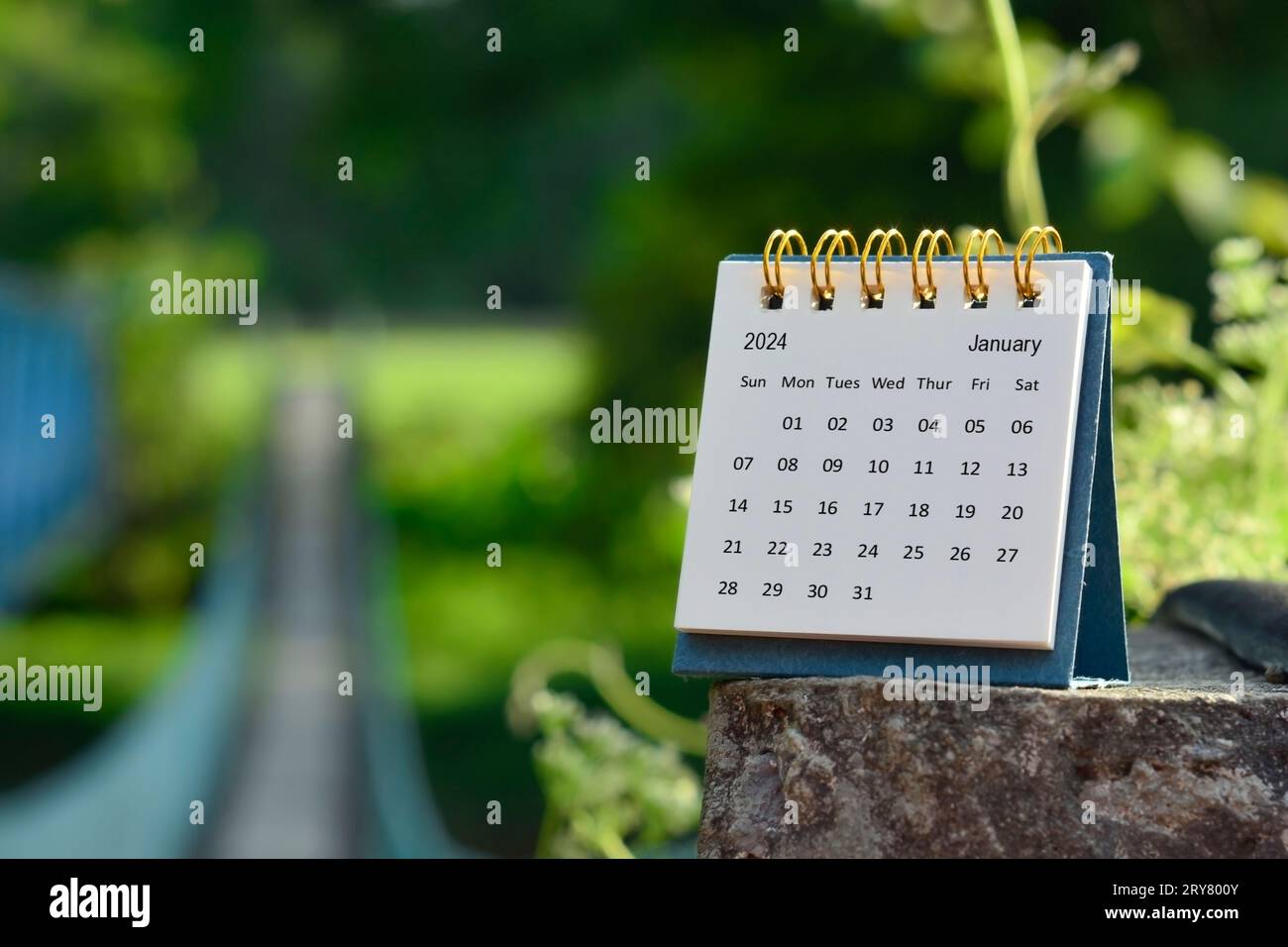 January 2024 calendar with green blurred background of hanging bridge