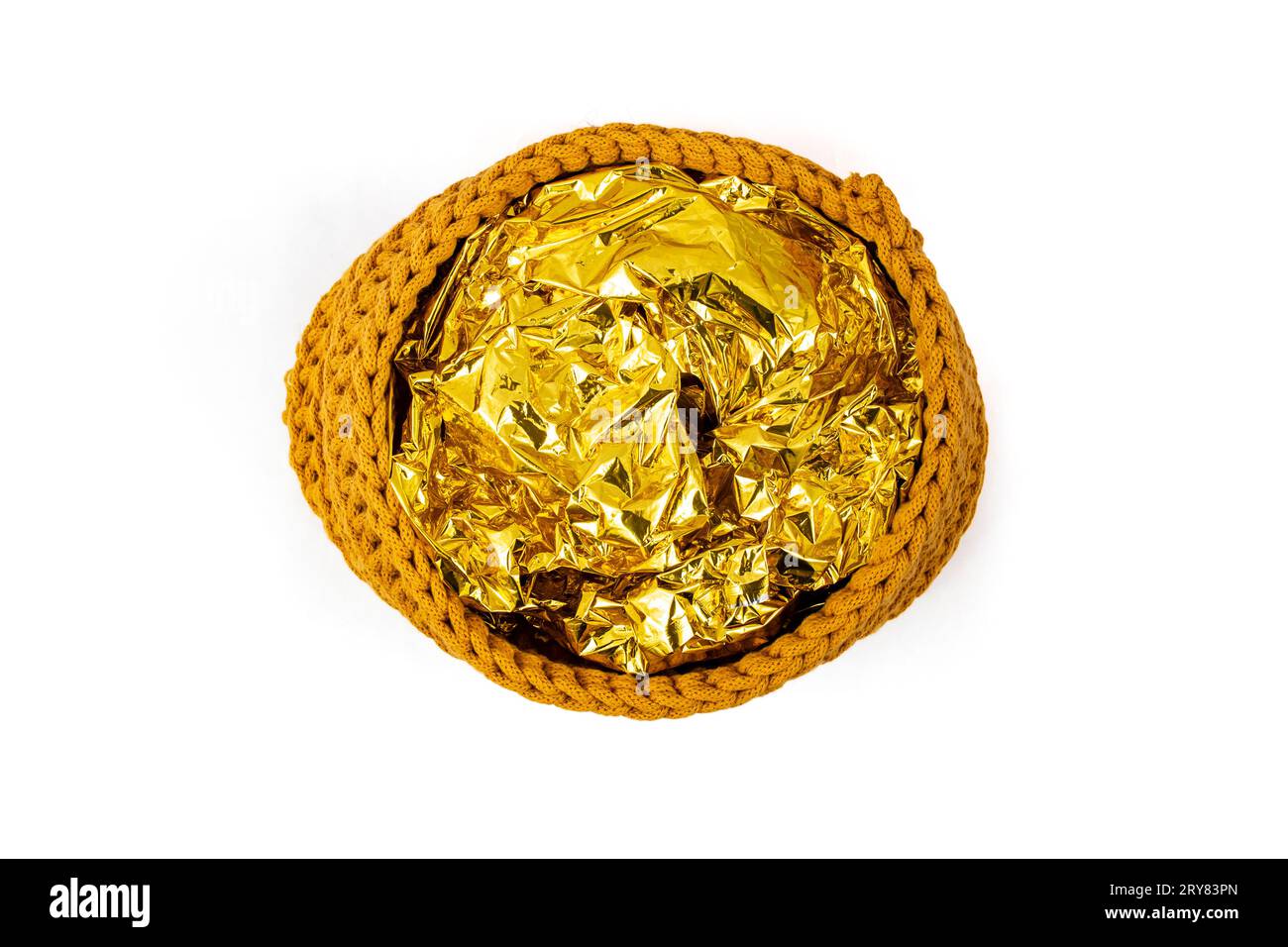Golden tin foil on a rope crochet basket, isolated on white, abstract