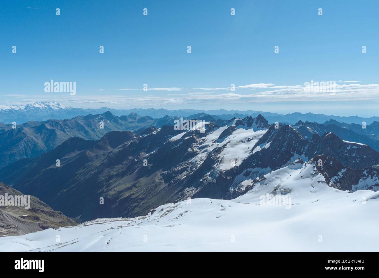 View from the summit of Gran Paradiso towards mountains and clouds ...