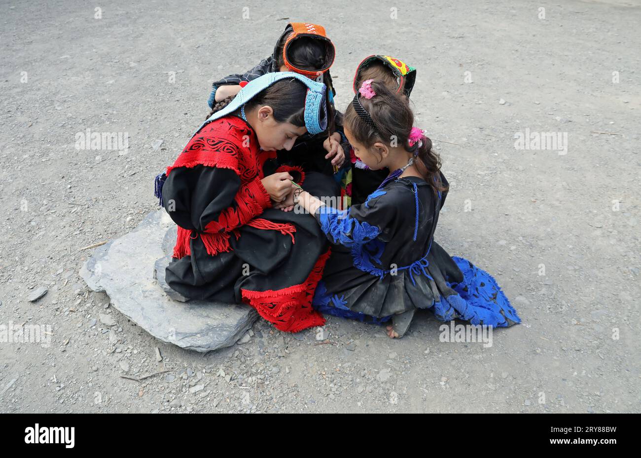 Kalash girls painting their hands with henna in preparation for the ...