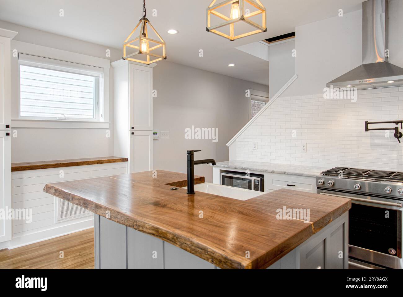 Luxury Modern White Kitchen with Organic Raw Edge Wood Countertop and