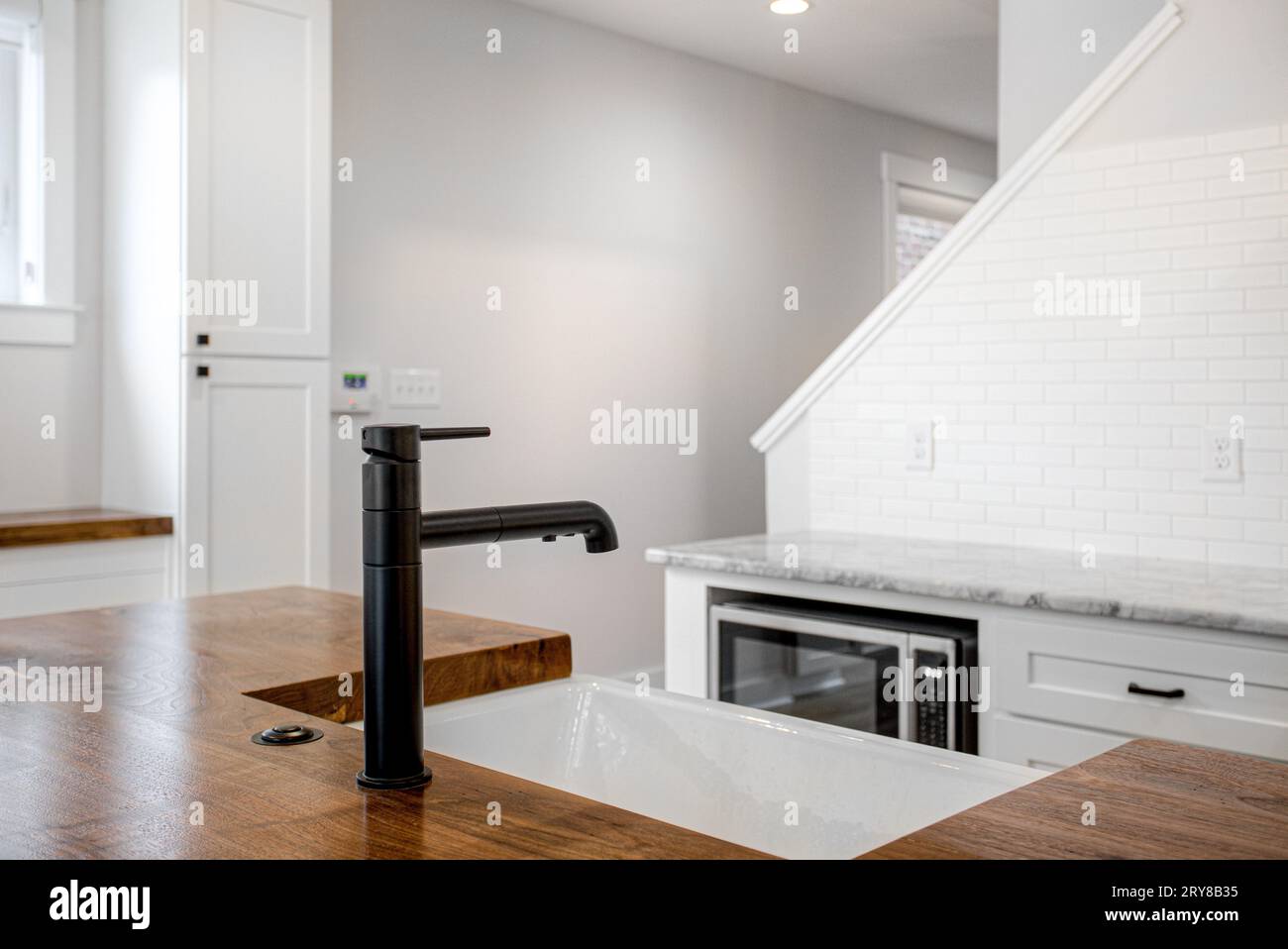 Luxury Modern White Kitchen with Organic Raw Edge Wood Countertop and