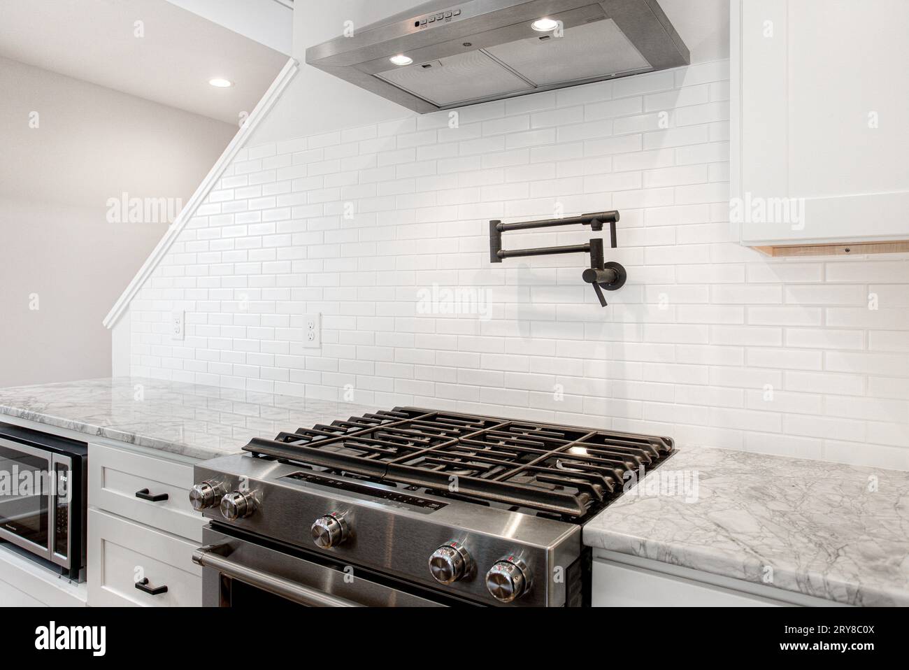 Pot Filler in Modern Kitchen Interior with Marble Countertop and Gas