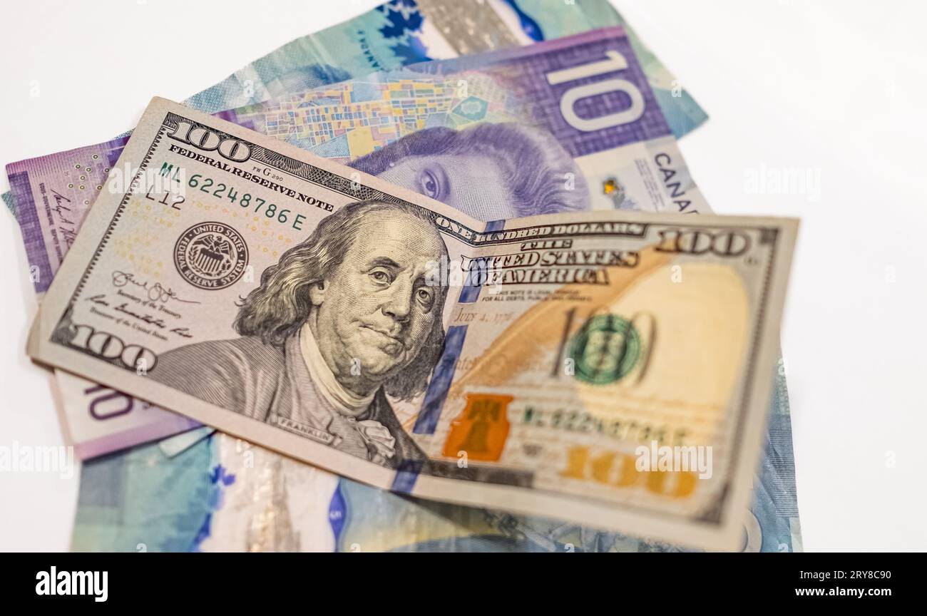 US American dollars vs Canadian dollars, which are important for board trading between these neighboring countries. Trading between USA and Canada. Cu Stock Photo