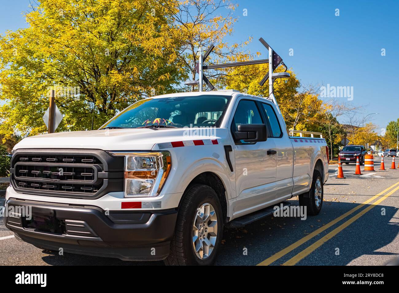 Road repair sign signal lights are flashing and detour with speed limit