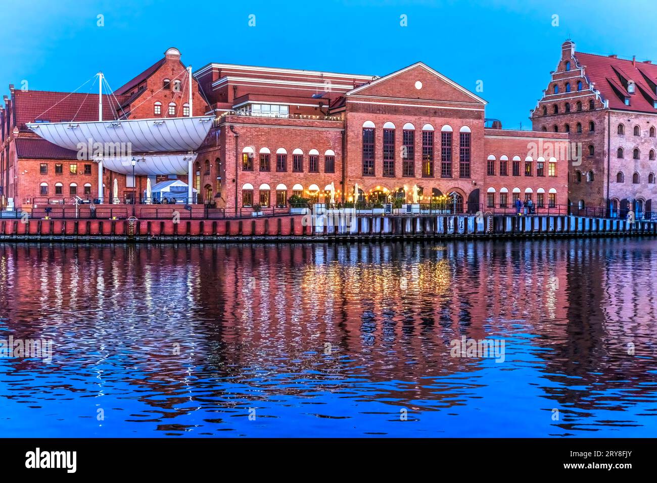 Colorful Polish Baltic F. Chopin Philharmonic Concert Hall Inner Harbor Port Motlawa River Historic Old Town of Gdansk Poland. Hall Built in 1897. Stock Photo