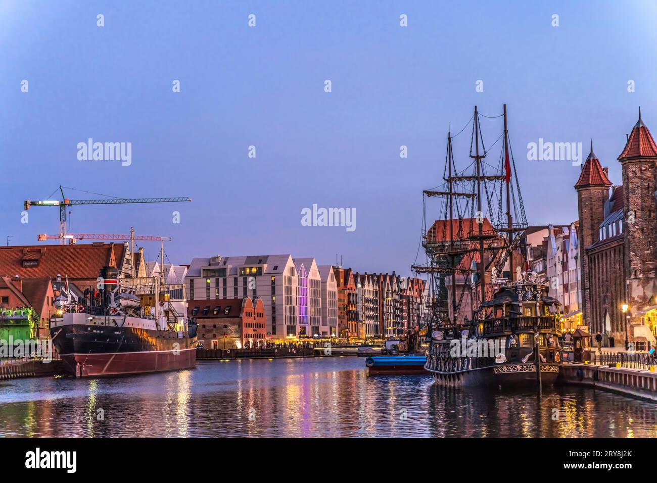 Colorful Ships Inner Harbor Port Night Illuminated Motlawa River Historic Old Town of Gdansk Poland. City formerly known as Danzig. Stock Photo