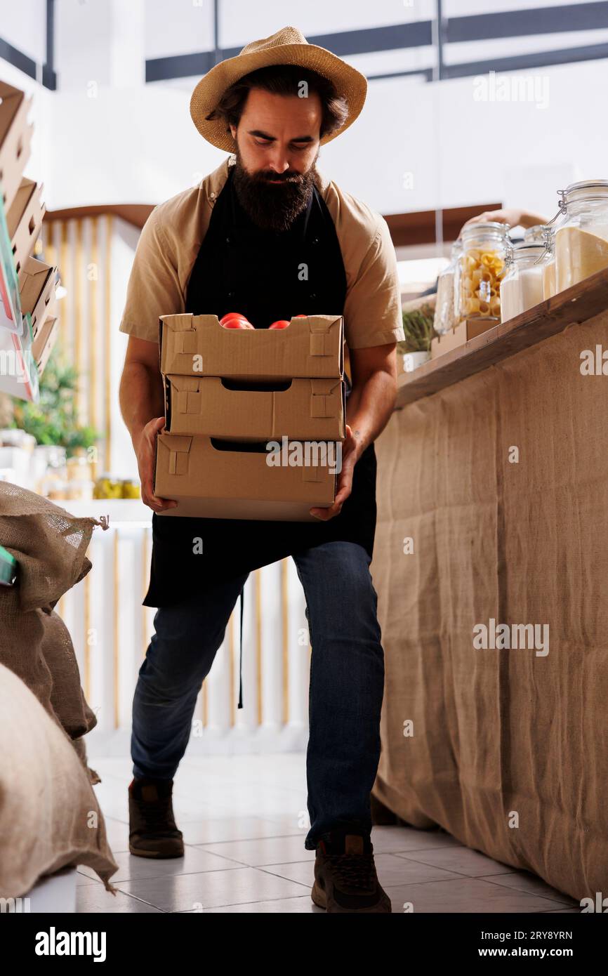 Farmer bringing crates full of vegetables from his own ethical eco