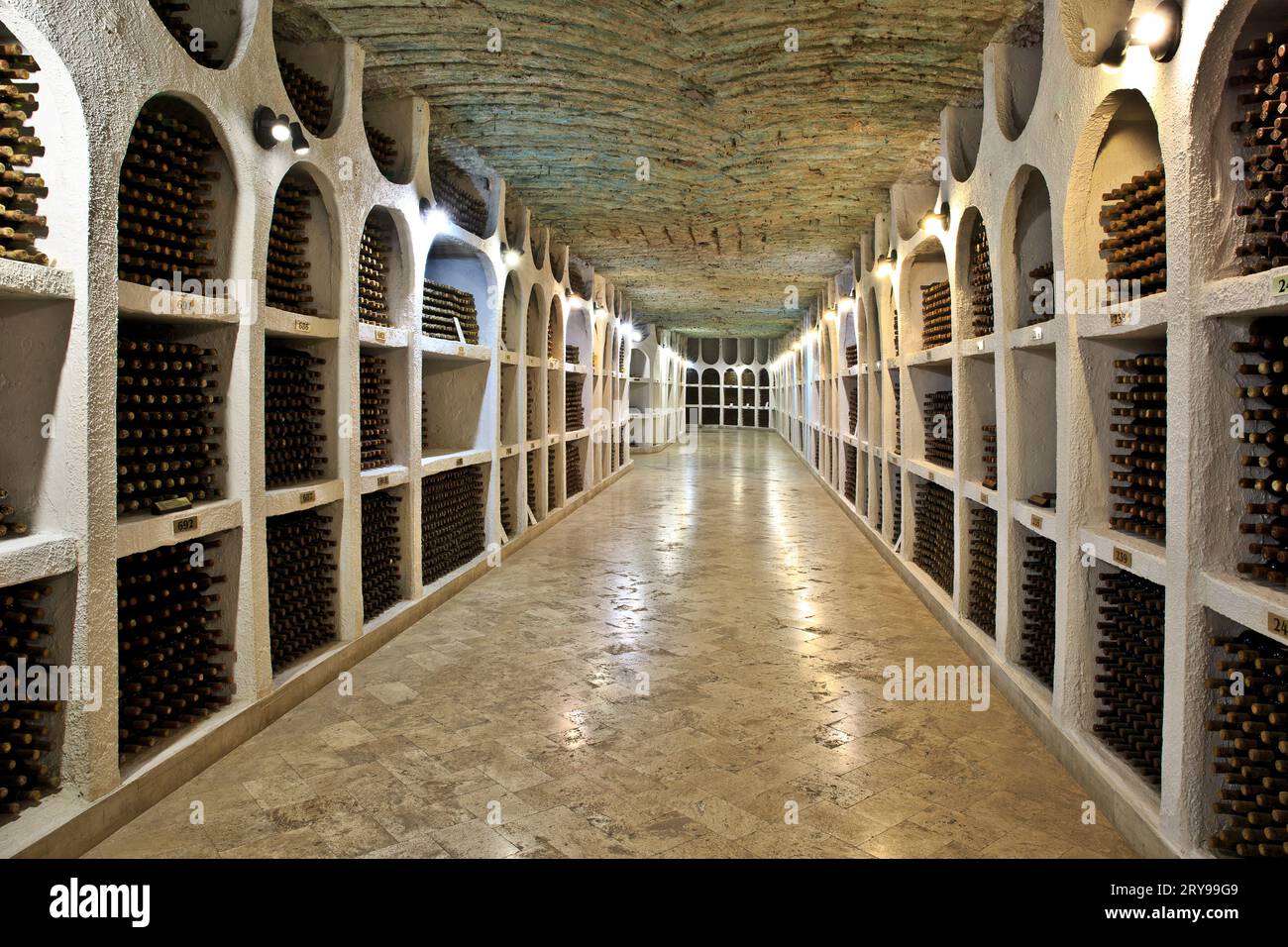 Stored wine bottles at the ancient underground limestone galleries of the Cricova Winery in Cricova, Moldova Stock Photo