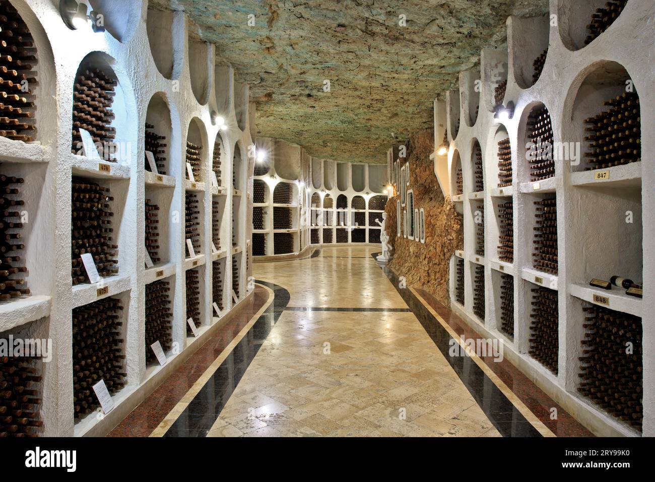 Stored wine bottles at the ancient underground limestone galleries of the Cricova Winery in Cricova, Moldova Stock Photo