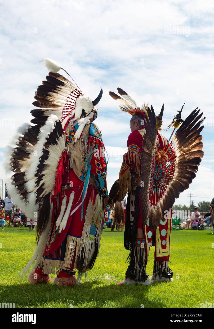 Two Native American Men in Full Regalia talking at the Little