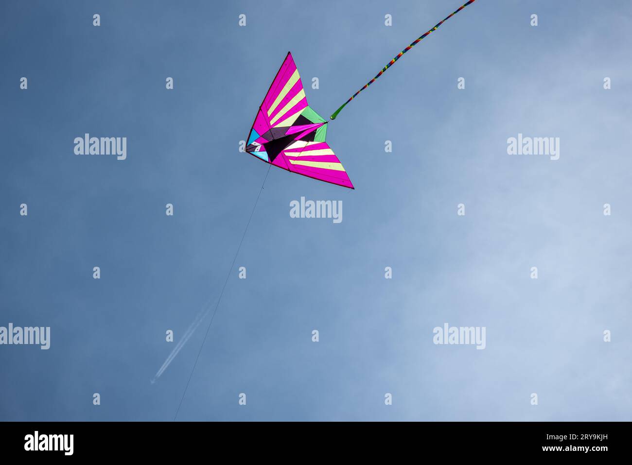 Colorful Asian silk kite flying against the blue sky Stock Photo Alamy