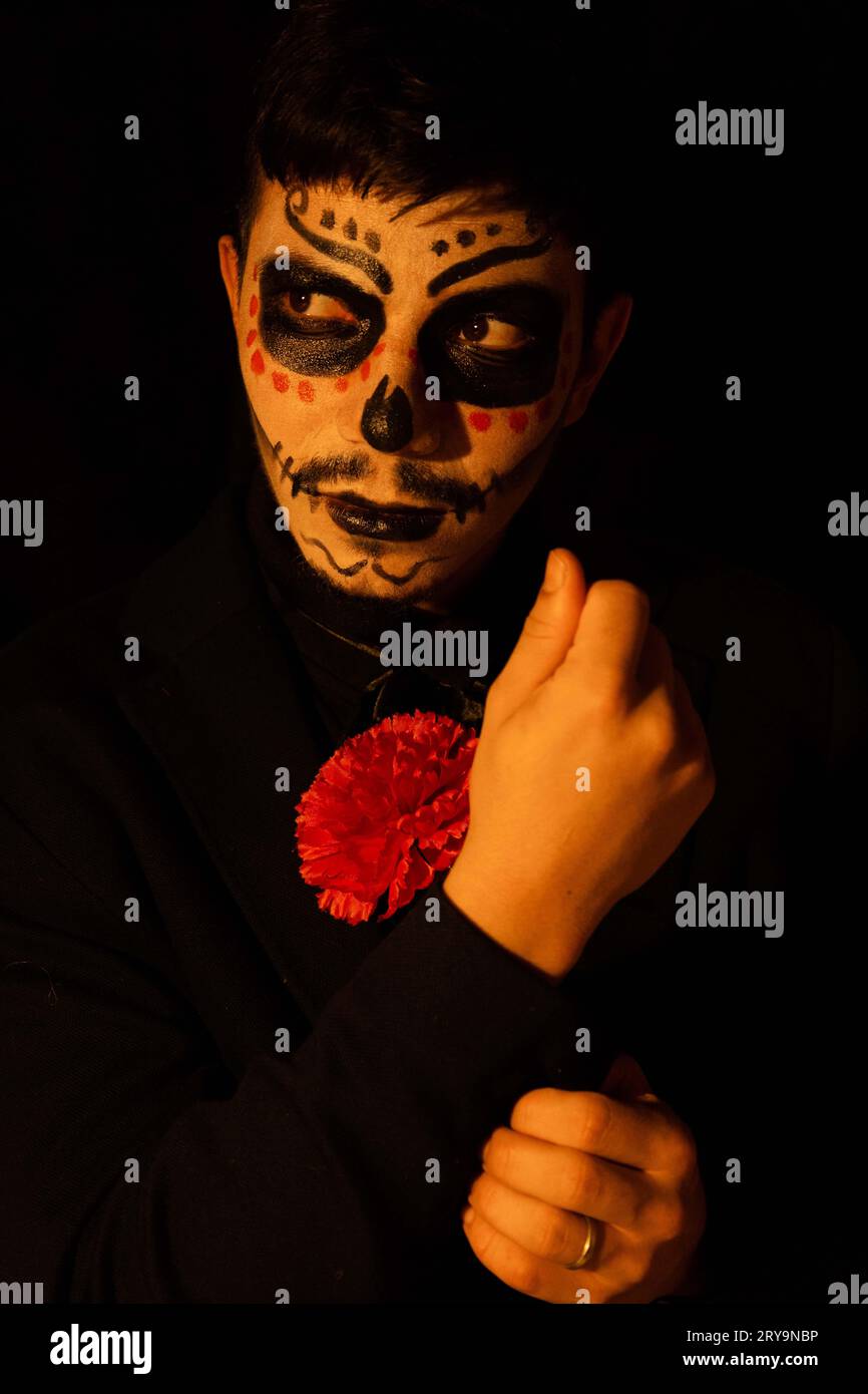 Subject dressed as Catrin adjusts his suit while looking to the side on ...