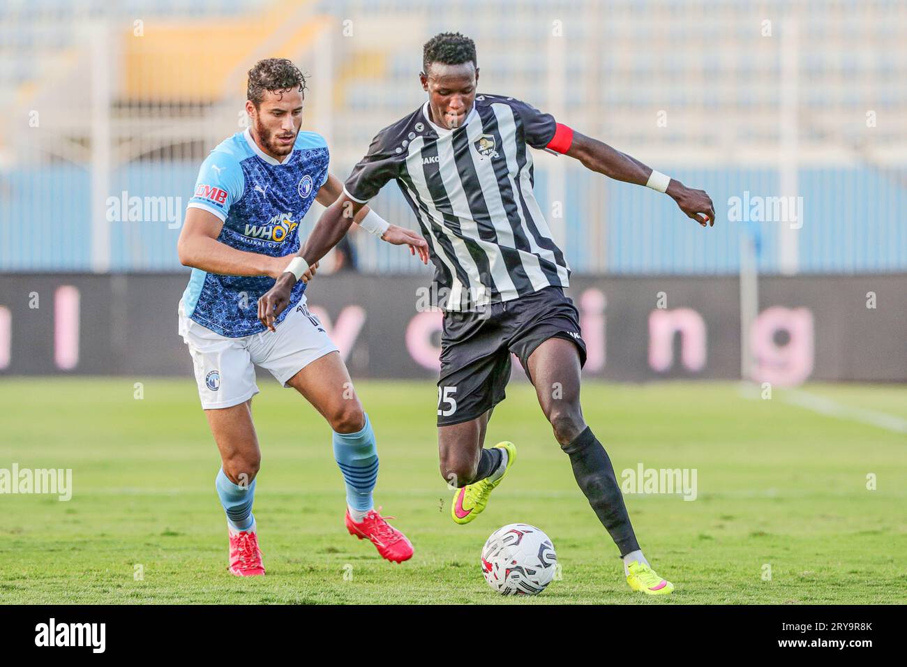 Cairo, Egypt. 29th Sep, 2023. Ramadan Sobhi (L) of Pyramids FC competes with Fitina Omborenga of Armee Patriotique Rwandaise during the Confederation of African Football (CAF) Champions League preliminary round match between Pyramids FC of Egypt and Armee Patriotique Rwandaise of Rwanda in Cairo, Egypt, Sept. 29, 2023. Credit: Ahmed Gomaa/Xinhua/Alamy Live News Stock Photo