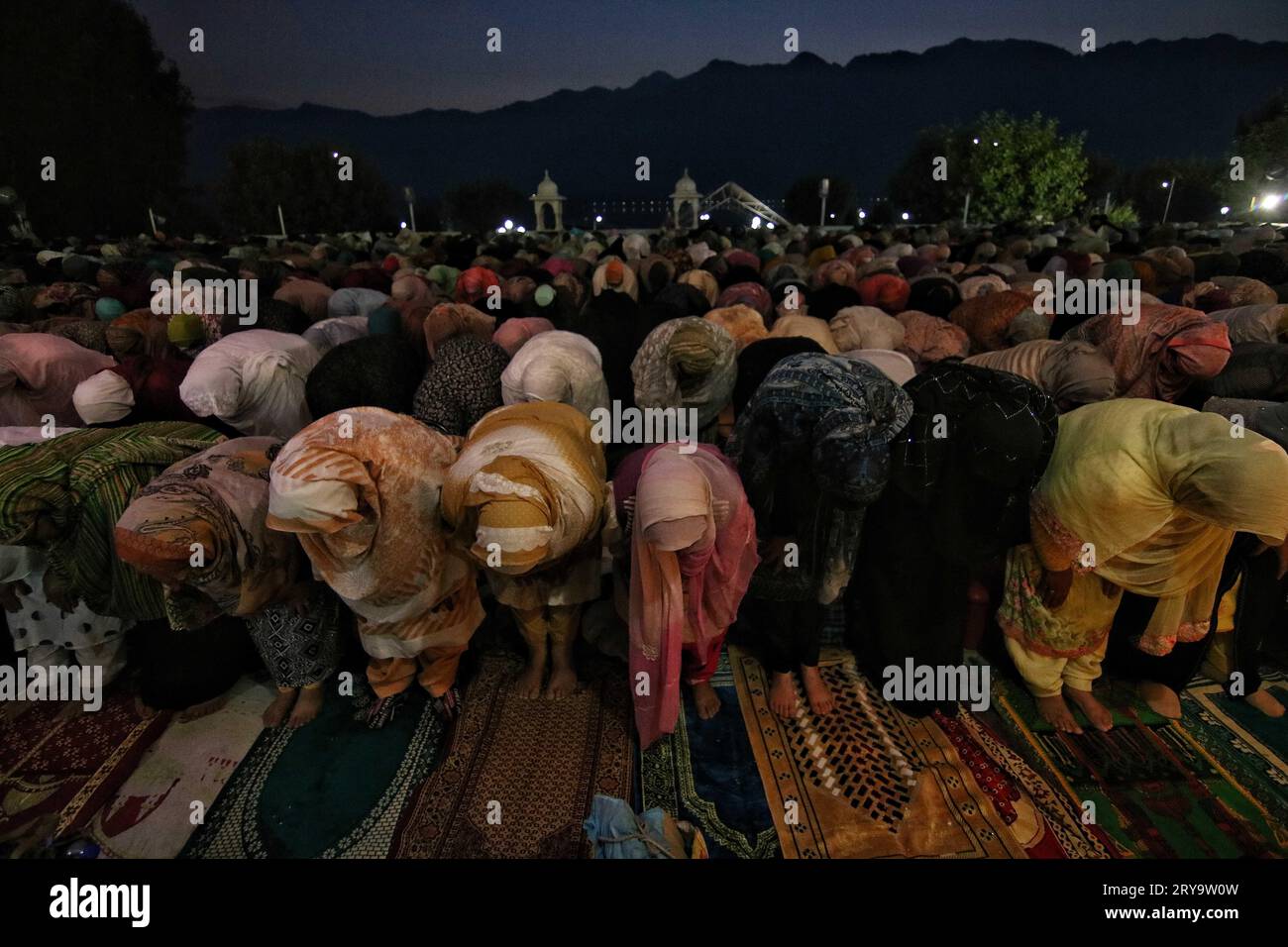 September 29, 2023, Srinagar Kashmir, India : Kashmiri Muslim women offer prayers during Mawlid-un-Nabi or Prophet Muhammad's (PBUH) birth anniversary in Dargah Hazratbal shrine in Srinagar. Hundreds of thousands of Muslims from all over Kashmir visit the Hazratbal shrine in Srinagar to pay obeisance on the birth anniversary of Prophet Mohammed (PBUH) . The shrine is highly revered by Kashmiri Muslims as it is believed to house a holy relic of the Prophet Mohammed (PBUH). The relic is displayed to the devotees on important Islamic days such as the Mawlid-un-Nabi when Muslims worldwide celebrat Stock Photo