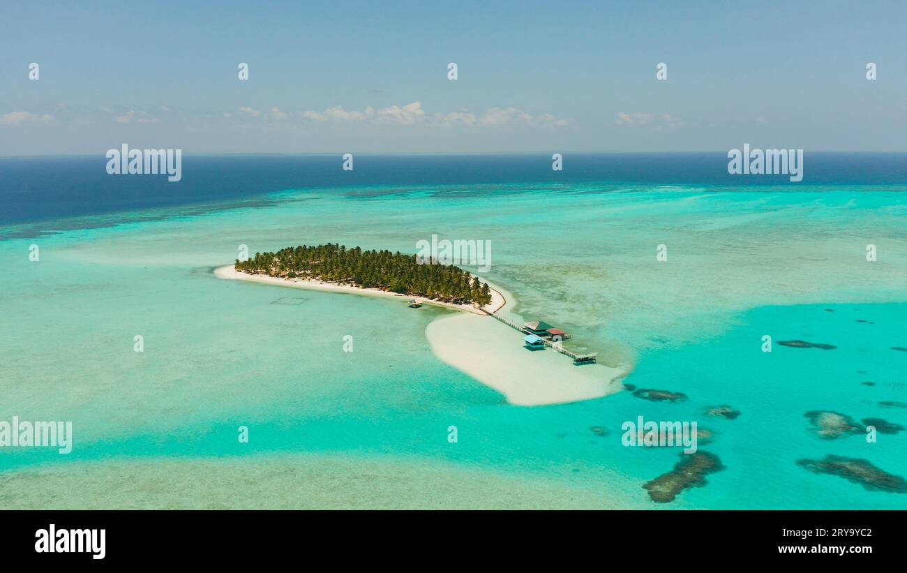 Tropical landscape: small island with beautiful beach, palm trees by turquoise water view from above. Onok Island, Balabac, Philippines. Summer and travel vacation concept Stock Photo