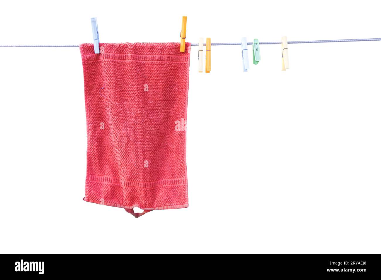 a red towel hanging to dry outdoors in the garden Stock Photo