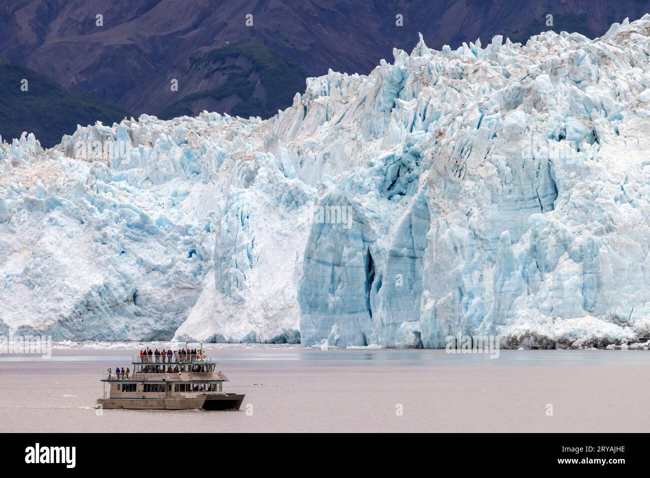 Tourist excursion vessel (St. Theodosius) near the Hubbard Glacier in Disenchantment Bay, Alaska, USA Stock Photo